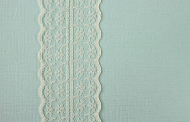 Lace on blue paper background frame