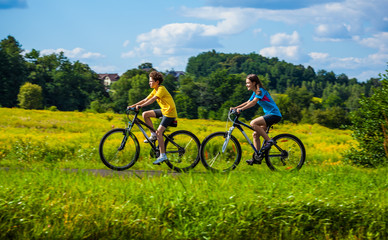 Healthy lifestyle - teenage girl and boy biking