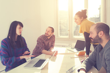 Young group of people discussing business plans.