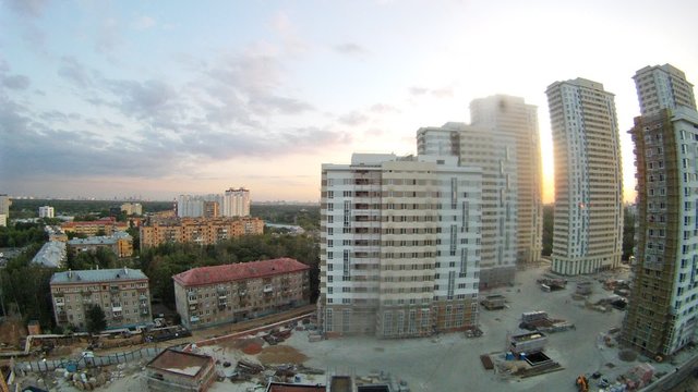 Old five-storey buildings stand near skyscrapers new buildings, time lapse