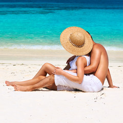 Couple in white relax on a beach at Maldives