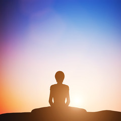 Woman in bound angle yoga pose meditating at sunset. Zen