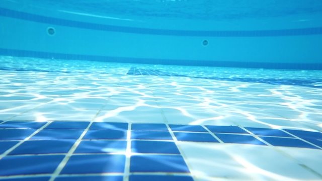 Underwater view of bottom of pure outdoor pool with tiles