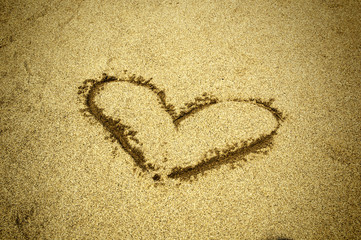 Heart drawn on sand. Horizontal composition.