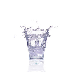 Fresh water splash in a glass isolated on white background