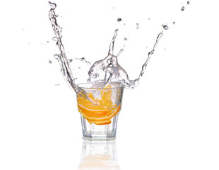 Orange or lemon slice fall in glass with water and make splash