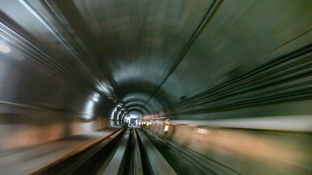 Subway train moving inside tunnel arriving in station