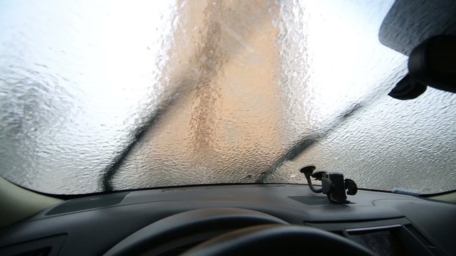 Inside view to crust of opaque ice on the outside car windows