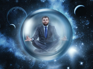 Businessman meditating in space