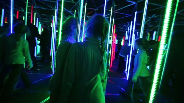 Little girl walks through labyrinth illuminated