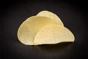Potato chips on a black background
