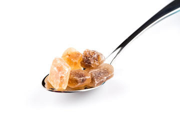 brown caramelized sugar in a wooden spoon