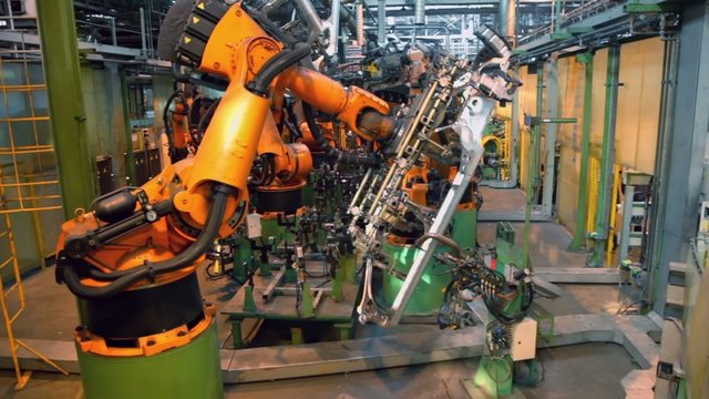 Car parts conveyer with automatic robotics at factory