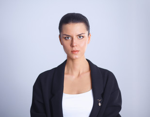 Fototapeta premium Young woman standing, isolated on gray background