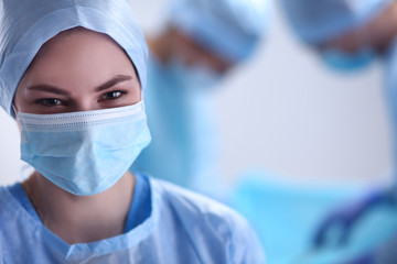 Team surgeon at work in operating room.