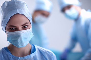 Team surgeon at work in operating room.