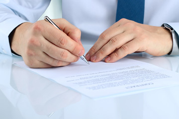 Businessman is signing a contract, business contract details