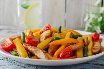 fried sliced chicken fillet bell peppers tomatoes  green beans