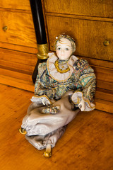 Harlequin doll on an antique cherry wood desk
