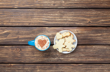 Cup of cappuccino with heart shape and cookies
