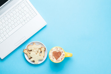 Cup of cappuccino with heart shape and cookies