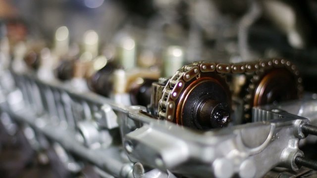 Closeup of disassembled gasoline car engine with moving gears