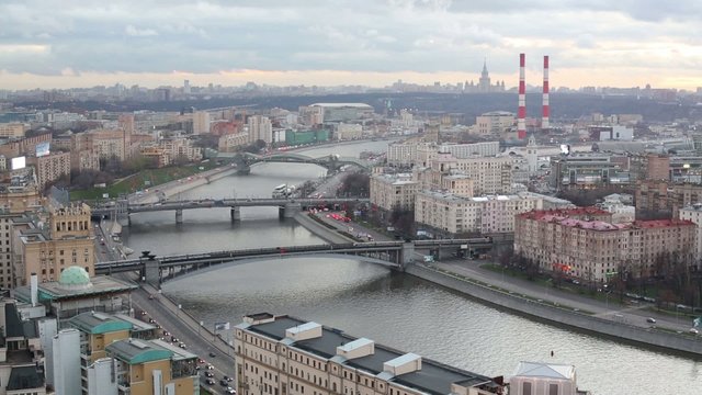 Cityscape with three bridges over the river and railway station