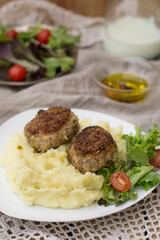 Meatballs cutlets with mashed potatoes and salad