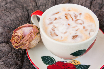 Iced Milk Tea in coffee cup on a wooden table in summer
