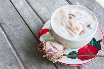 Iced Milk Tea in coffee cup on a wooden table in summer