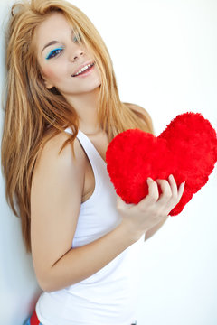 Beautiful redhair woman with hearts in her hands 