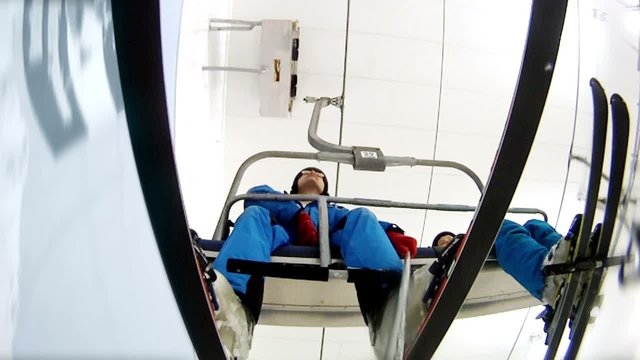 Father with son go on ski-lift in ski complex