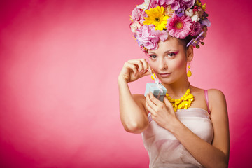 Spring girl with jewelry gift box and flowers hair