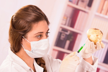 young beautiful woman biologist experimenting with white onion