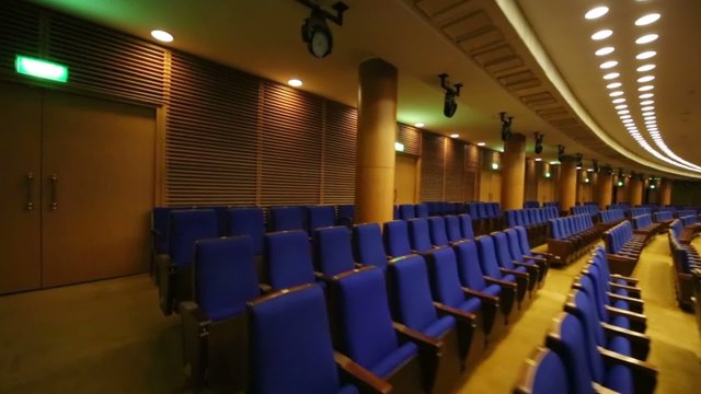 Back rows of seats in large hall for presentations 
