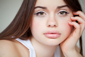 beautiful woman resting on the bed in white bedroom 