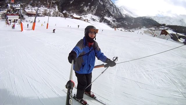 Skier rises up on mountain on mountain top rope hoist