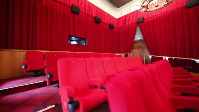 Big hall with red curtains and stairs in cinema at GUM