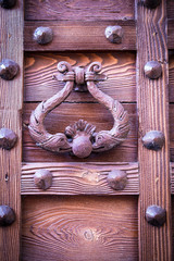 ancient door knocker of a medieval portal
