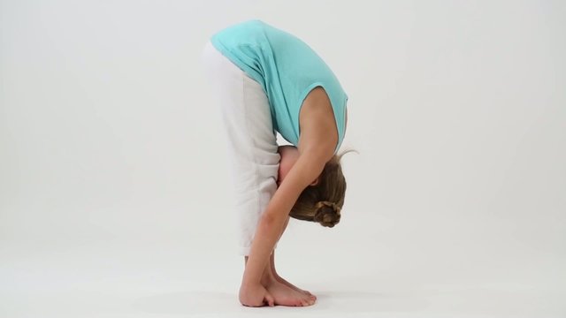 Flexible girl doing gymnastic exercise, gets up and sits down