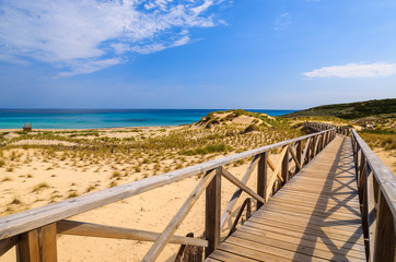 Fototapeta na wymiar Wooden footbridge to Cala Sa Mesquida beach, Majorca island