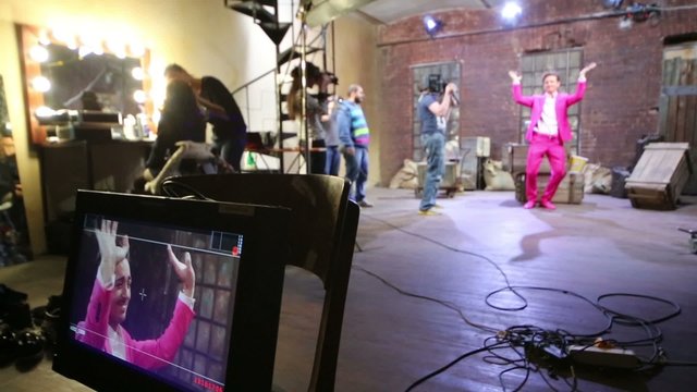 Movie set of musical video clip with dancer in pink suit