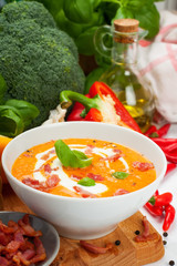 Carrot sweet pepper cream soup with bacon