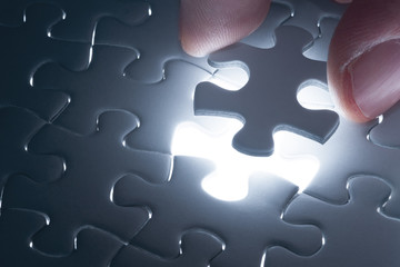 Missing jigsaw puzzle piece with light glow, business concept