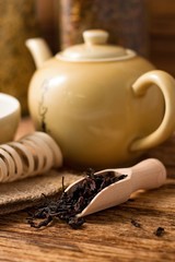 Wooden spoon full of dry tea leafs