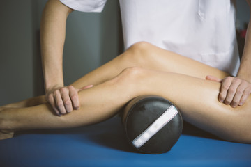 Beautiful young woman relaxing with hand massage at beauty spa