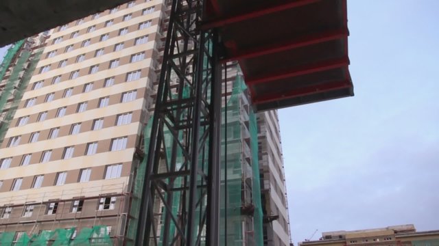 Elevator moves down at construction site of dwelling complex