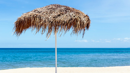 Fototapeta na wymiar The beautiful straw umbrella at the beach. - at Koh Samui Thaila