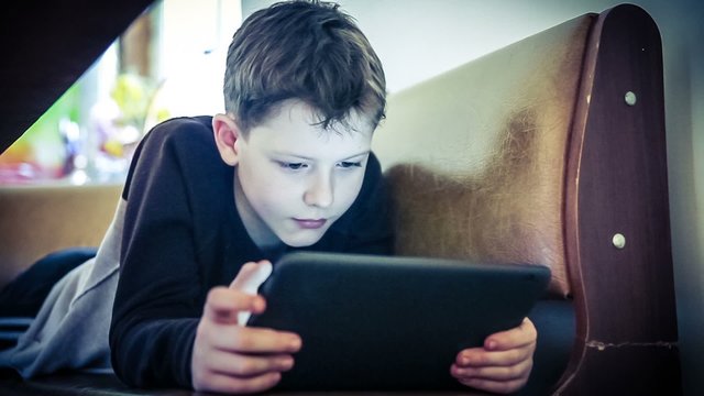 teenager boy plays in tablet color cross process instagram hd