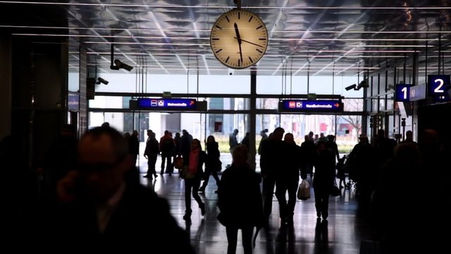 Railroad station with clock people in Vienna, indoor.